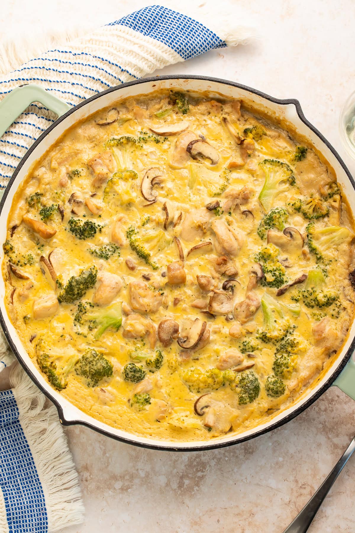 Overhead view of complete Whole30 chicken broccoli casserole in black cast iron skillet