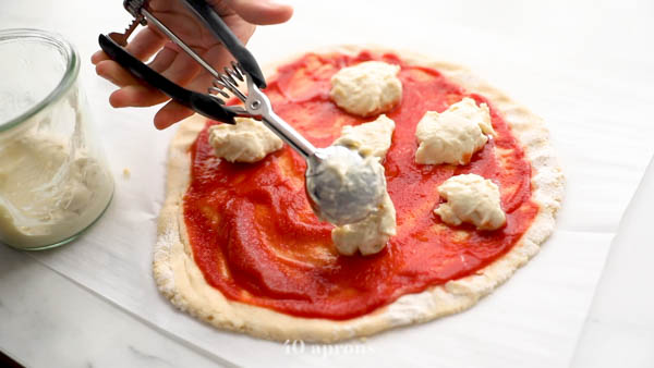 Use a disher for dairy-free cheese on top of paleo pizza crust