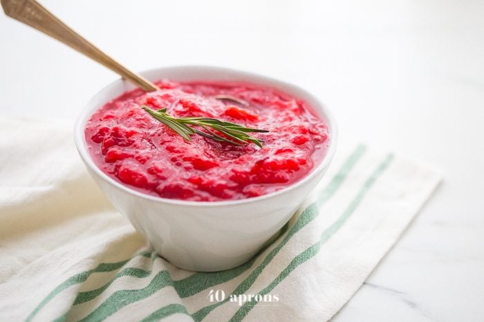This Instant Pot Whole30 cranberry sauce with apples and rosemary is the perfect Whole30 cranberry sauce: sweet and tart with no added sweeteners at all! It's the perfect addition to any Whole30 Thanksgiving table and goes beautifully with my Whole30 green bean casserole. You'll love this Instant Pot Whole30 cranberry sauce with apples and rosemary because it's so easy and quick yet gourmet!