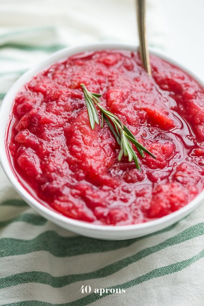 This Instant Pot Whole30 cranberry sauce with apples and rosemary is the perfect Whole30 cranberry sauce: sweet and tart with no added sweeteners at all! It's the perfect addition to any Whole30 Thanksgiving table and goes beautifully with my Whole30 green bean casserole. You'll love this Instant Pot Whole30 cranberry sauce with apples and rosemary because it's so easy and quick yet gourmet!