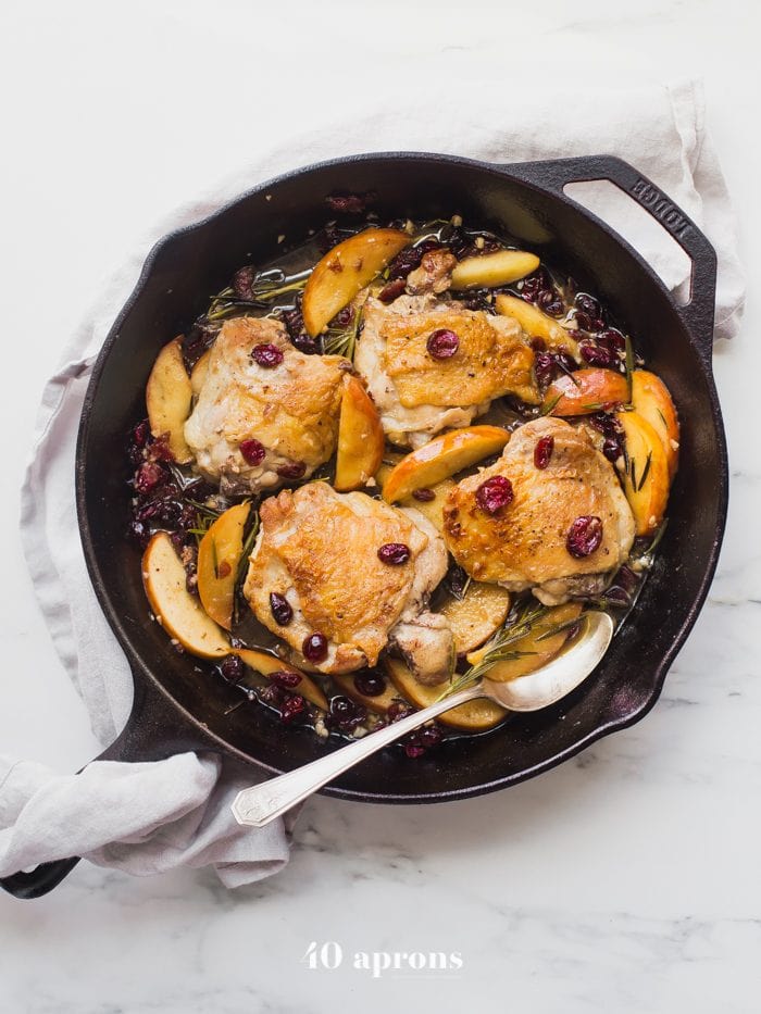 These paleo cranberry apple chicken thighs with rosemary are such a delicious paleo fall recipe. With organic cranberry juice and dried cranberries, these paleo cranberry apple chicken thighs are an easy and quick paleo dinner that’s elegant enough for company. 