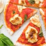 A whole paleo pizza recipe crust with a slice cut out