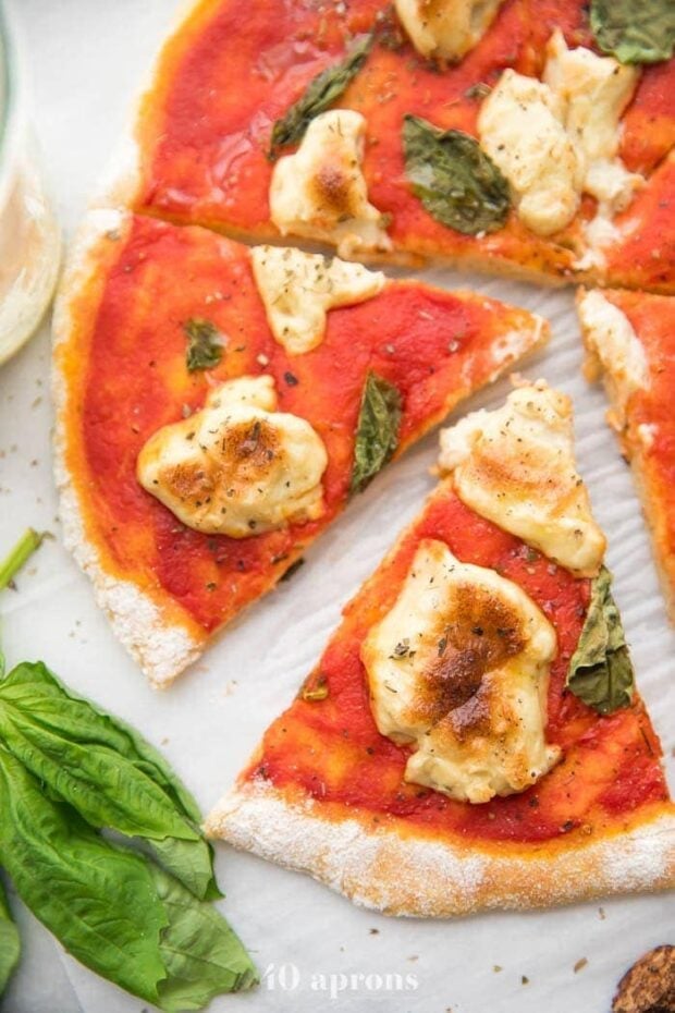 A whole paleo pizza recipe crust with a slice cut out