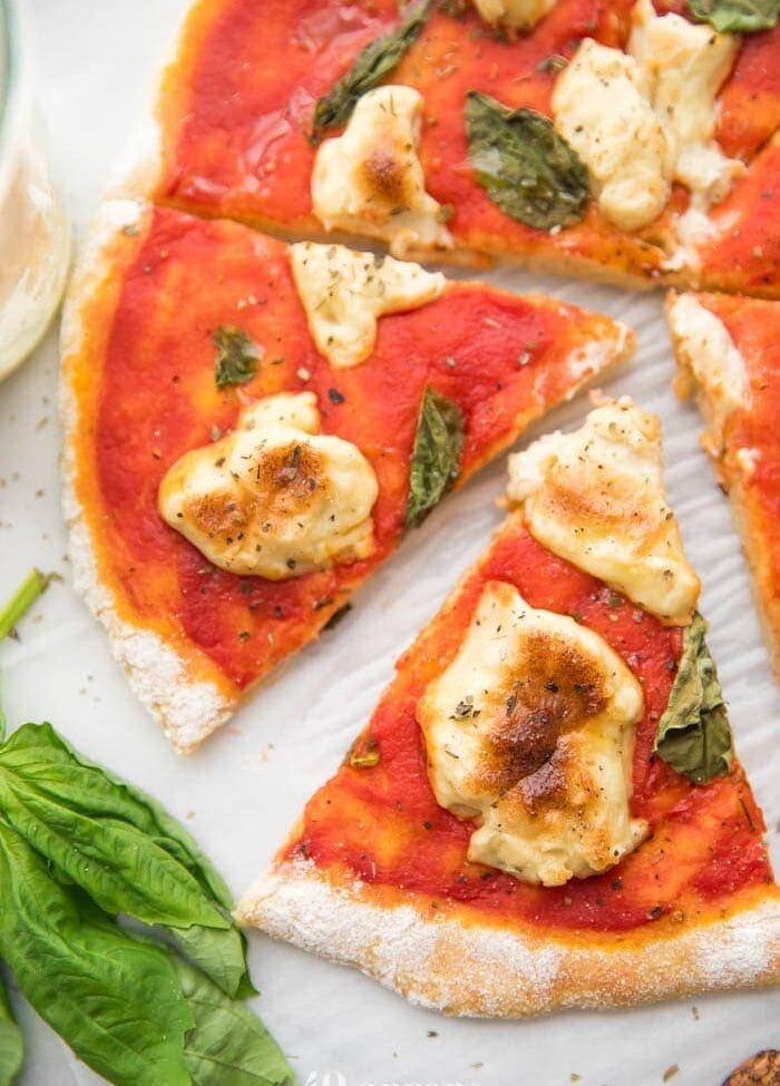 A whole paleo pizza recipe crust with a slice cut out