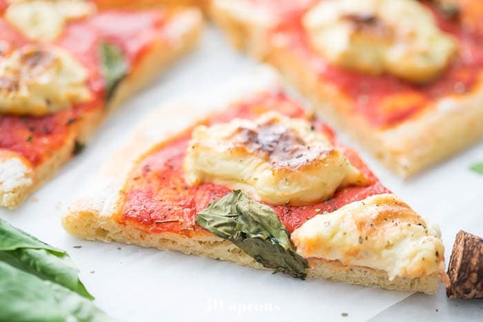 A slice of paleo pizza with an airy crust