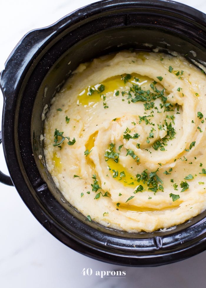 These Whole30 Crockpot mashed potatoes are so easy and creamy. Lactose-free and with a vegan or dairy-free option, these Whole30 Crockpot mashed potatoes are absolutely perfect for any Whole30 Thanksgiving or vegan Thanksgiving table, since they cook while you work on the rest of dinner! Rich and garlicky, these Whole30 Crockpot mashed potatoes will totally become a Whole30 Thanksgiving or vegan Thanksgiving tradition.
