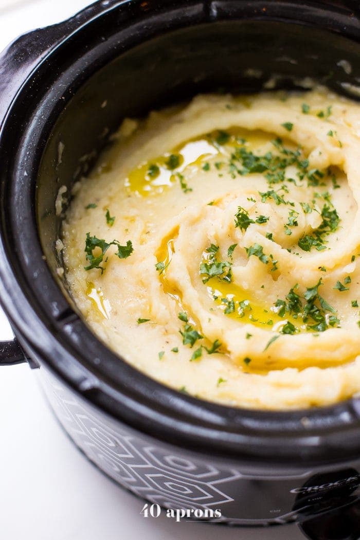 These Whole30 Crockpot mashed potatoes are so easy and creamy. Lactose-free and with a vegan or dairy-free option, these Whole30 Crockpot mashed potatoes are absolutely perfect for any Whole30 Thanksgiving or vegan Thanksgiving table, since they cook while you work on the rest of dinner! Rich and garlicky, these Whole30 Crockpot mashed potatoes will totally become a Whole30 Thanksgiving or vegan Thanksgiving tradition.