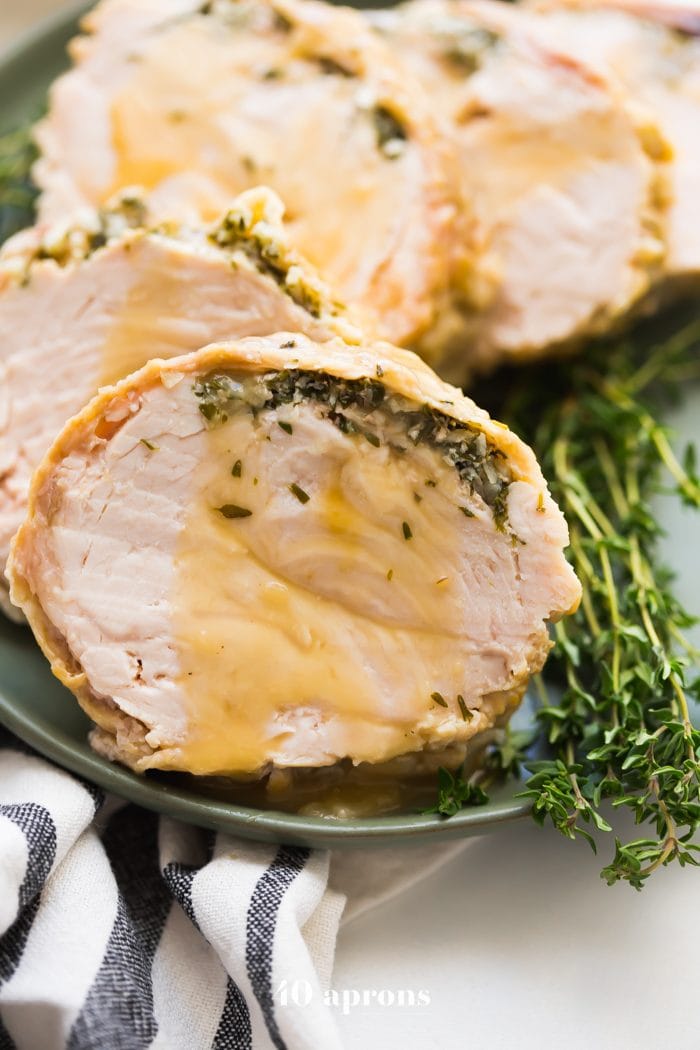 This Whole30 Instant Pot turkey breast with gravy is quick, so delicious, and totally Whole30 compliant. Brined with a garlic-herb butter under the skin, this Whole30 turkey breast and the gravy are both made in the Instant Pot, making Thanksgiving easier! You'll love this Whole30 Instant Pot turkey breast and gravy, because the meat is so tender, and the gravy is so easy. Perfect for any Whole30 Thanksgiving or paleo Thanksgiving table. 