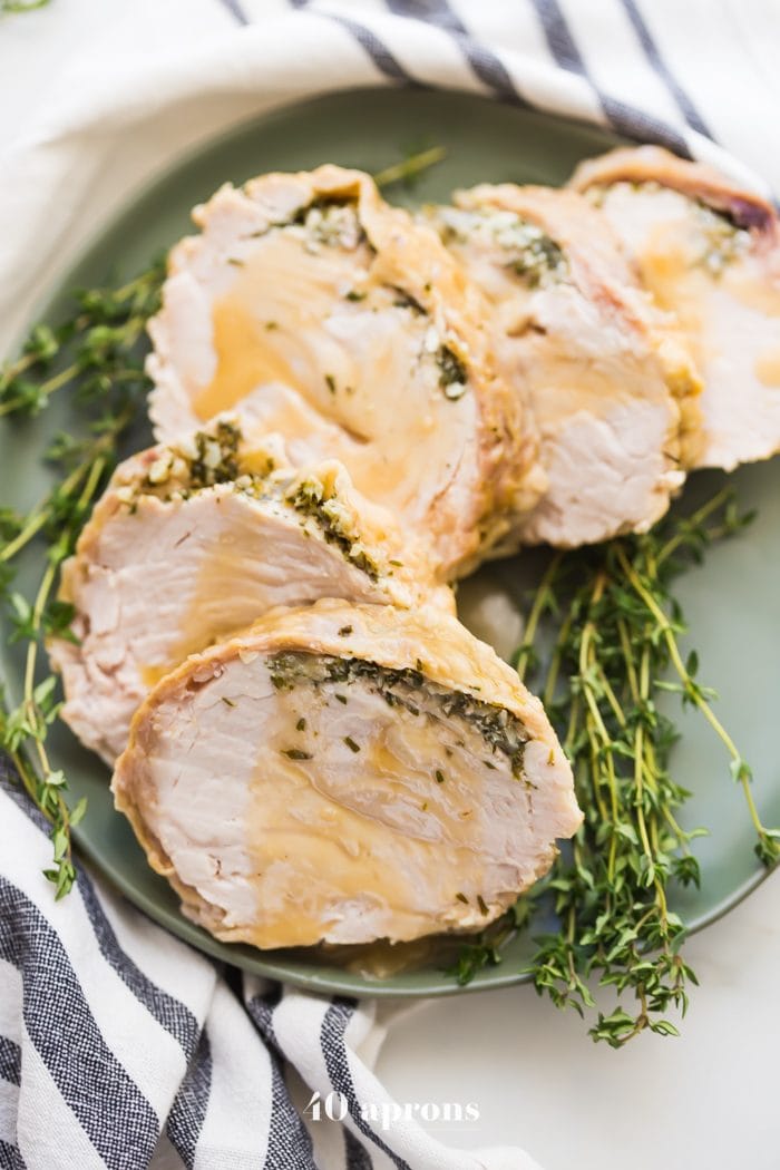 This Whole30 Instant Pot turkey breast with gravy is quick, so delicious, and totally Whole30 compliant. Brined with a garlic-herb butter under the skin, this Whole30 turkey breast and the gravy are both made in the Instant Pot, making Thanksgiving easier! You'll love this Whole30 Instant Pot turkey breast and gravy, because the meat is so tender, and the gravy is so easy. Perfect for any Whole30 Thanksgiving or paleo Thanksgiving table. 