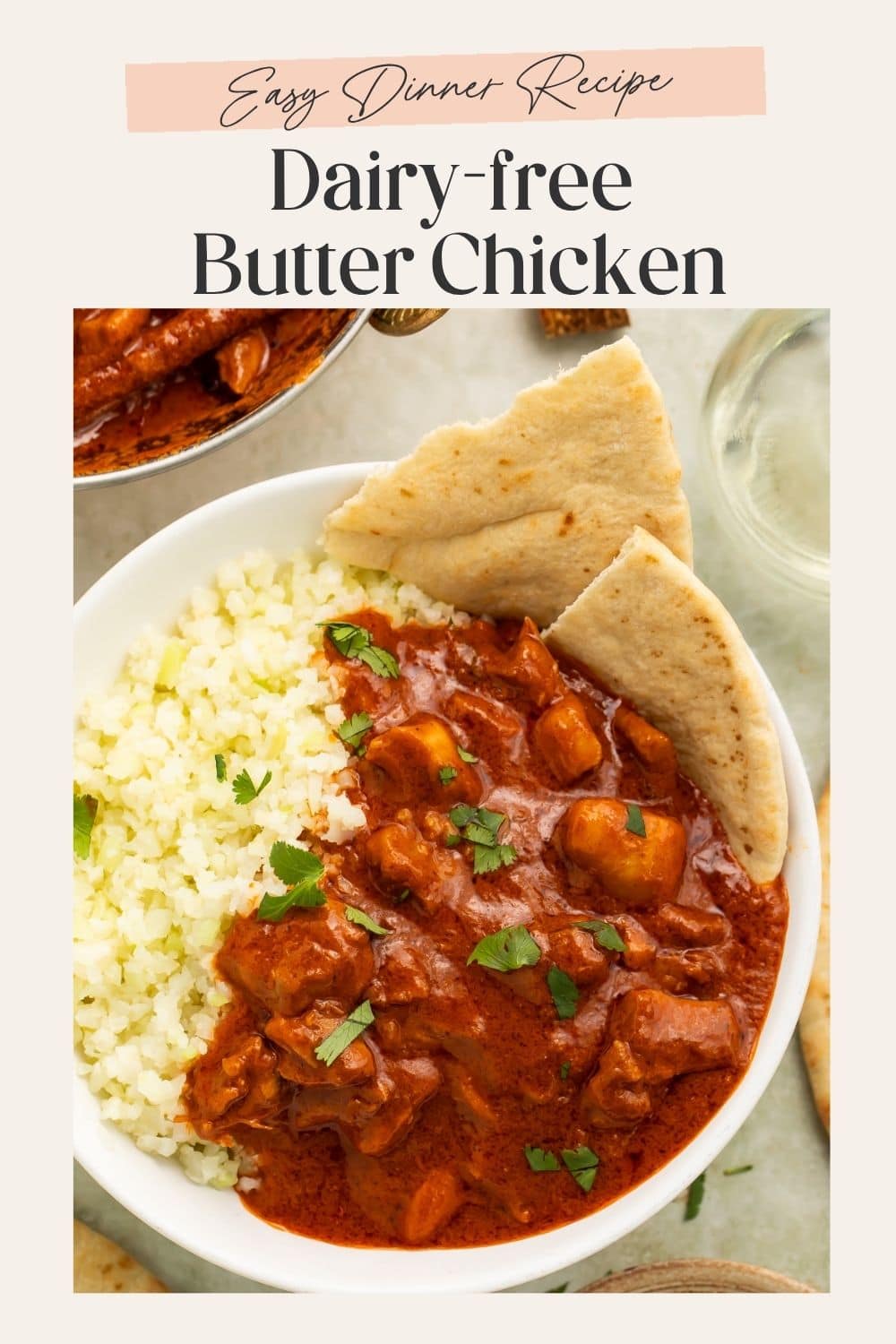 Close up of a bowl of Whole30 Butter Chicken with cauliflower rice and naan. There is a frame on the image with Pinterest-optimised text.