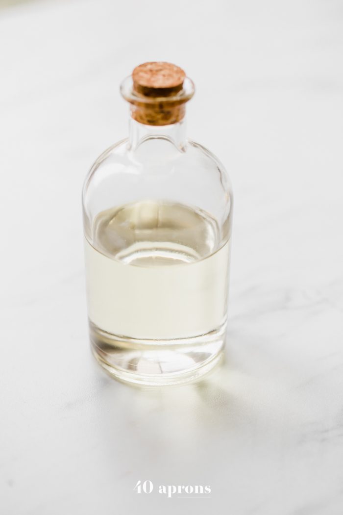 Fractionated coconut oil (liquid coconut oil) in a jar with a cork