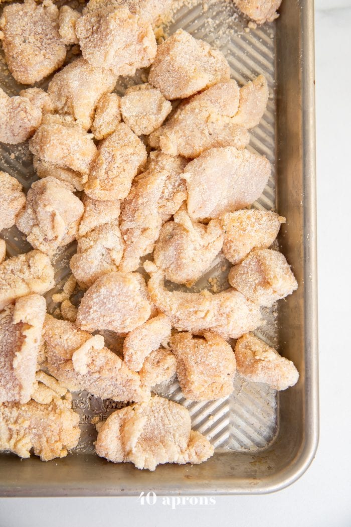 Whole30 chicken nuggets recipe breaded on a baking sheet