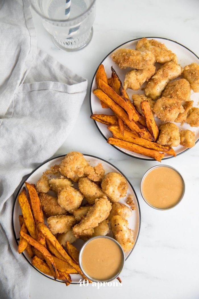 Paleo Whole30 chicken nuggets recipe Chick-Fil-A style on a plate with dipping sauce sauce and sweet potato fries