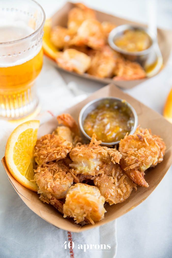 Whole30 coconut shrimp with orange sauce in a container