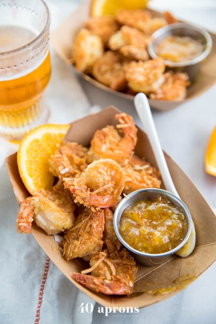 Whole30 coconut shrimp with orange sauce in a container