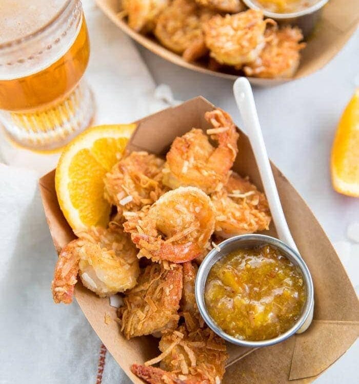 Whole30 coconut shrimp with orange sauce in a container