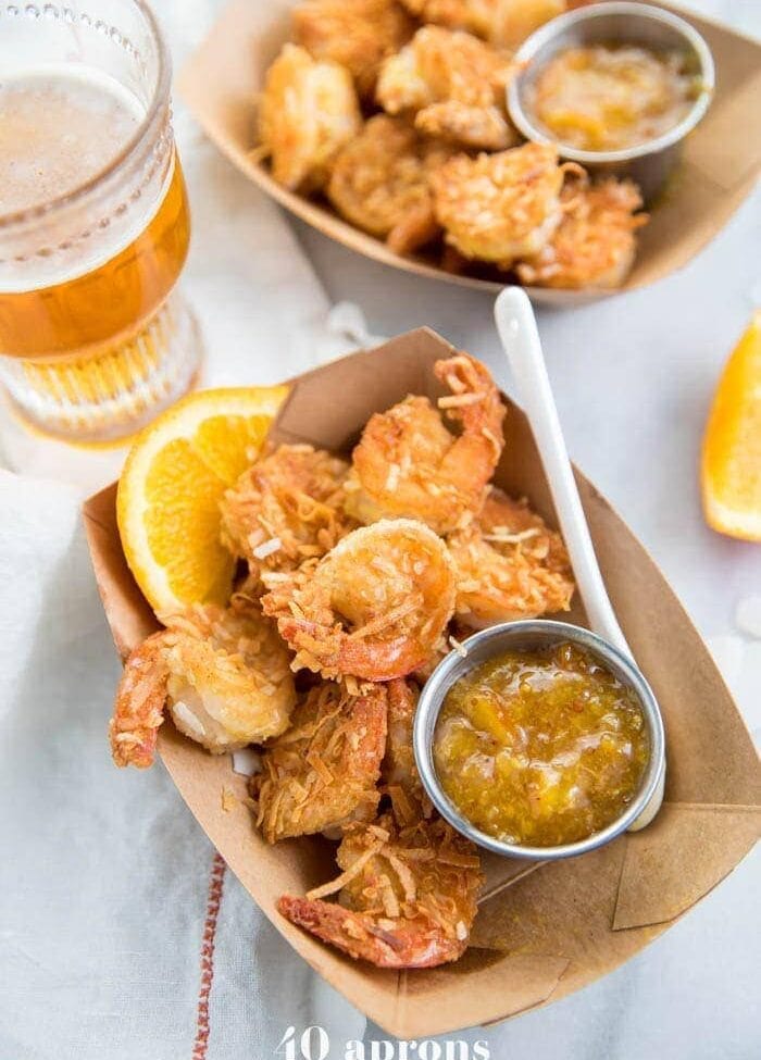 Whole30 coconut shrimp with orange sauce in a container