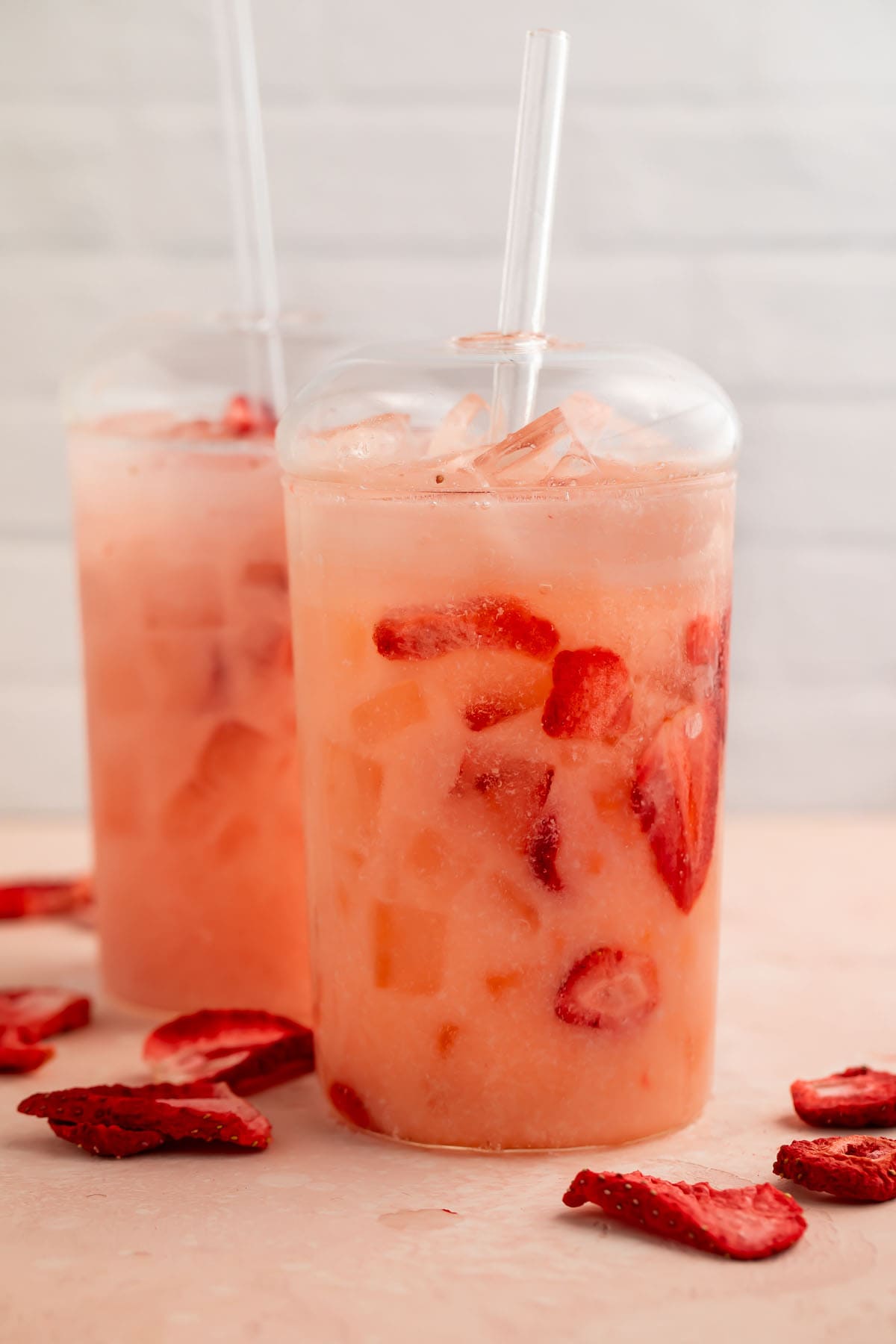 A Starbucks pink drink copycat in a glass on a table.