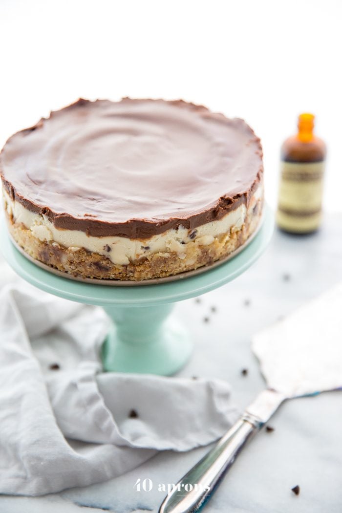 Whole vegan no bake cookie dough cheesecake on a cake stand