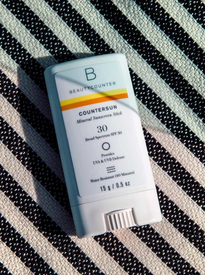 Beautycounter Countersun Mineral Sunscreen Stick on a striped background
