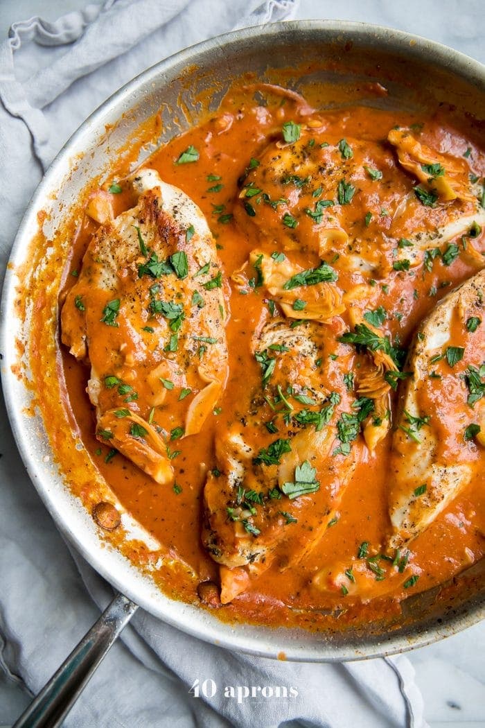 Creamy tomato artichoke chicken (Whole30, paleo) in a skillet