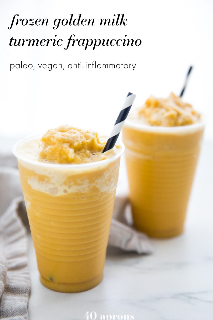Two frozen golden milk turmeric frappuccinos in to-go cups with black and white straws