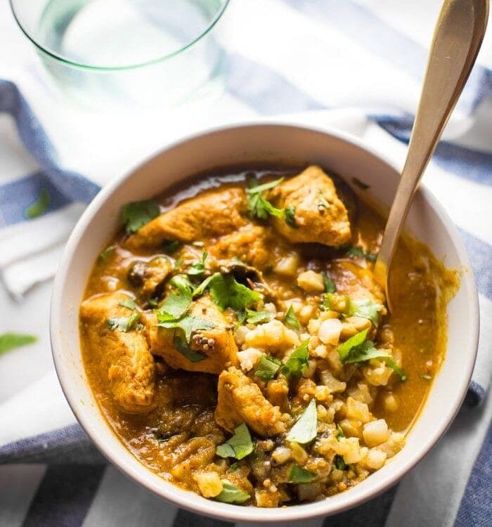 Whole30 chicken curry in a bowl with cauliflower rice