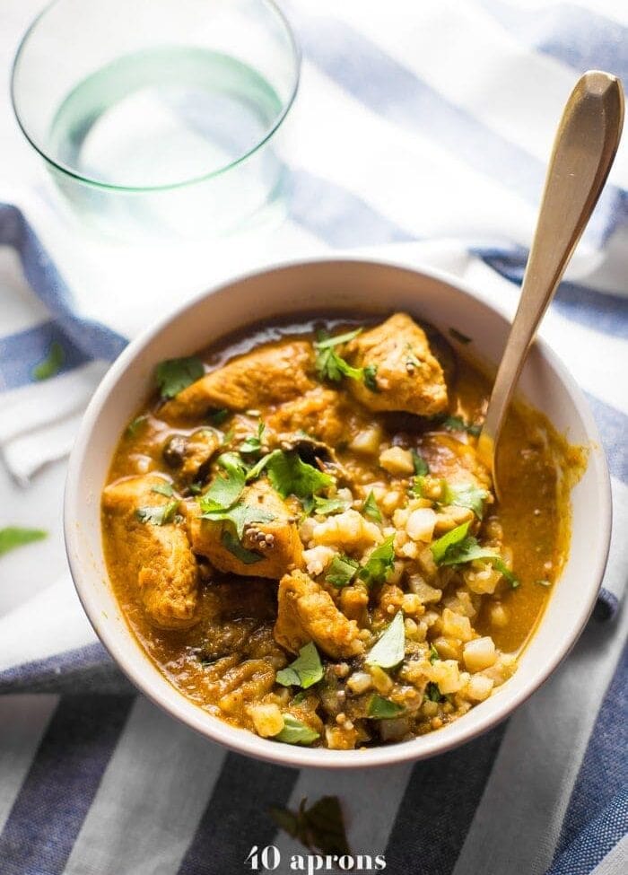Whole30 chicken curry in a bowl with cauliflower rice