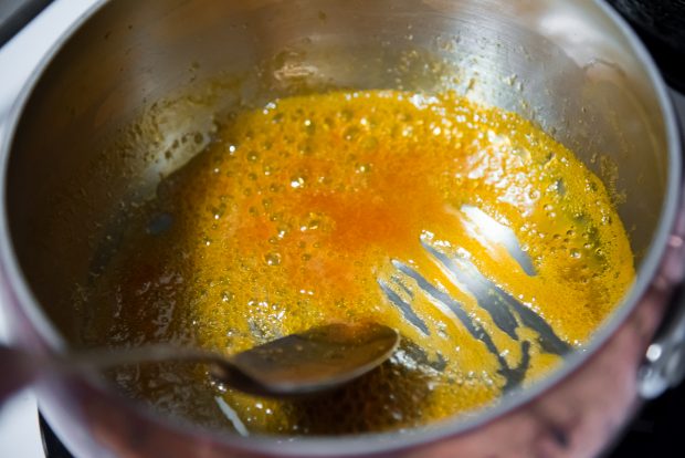 orange glaze bubbling away to reduce in a pot