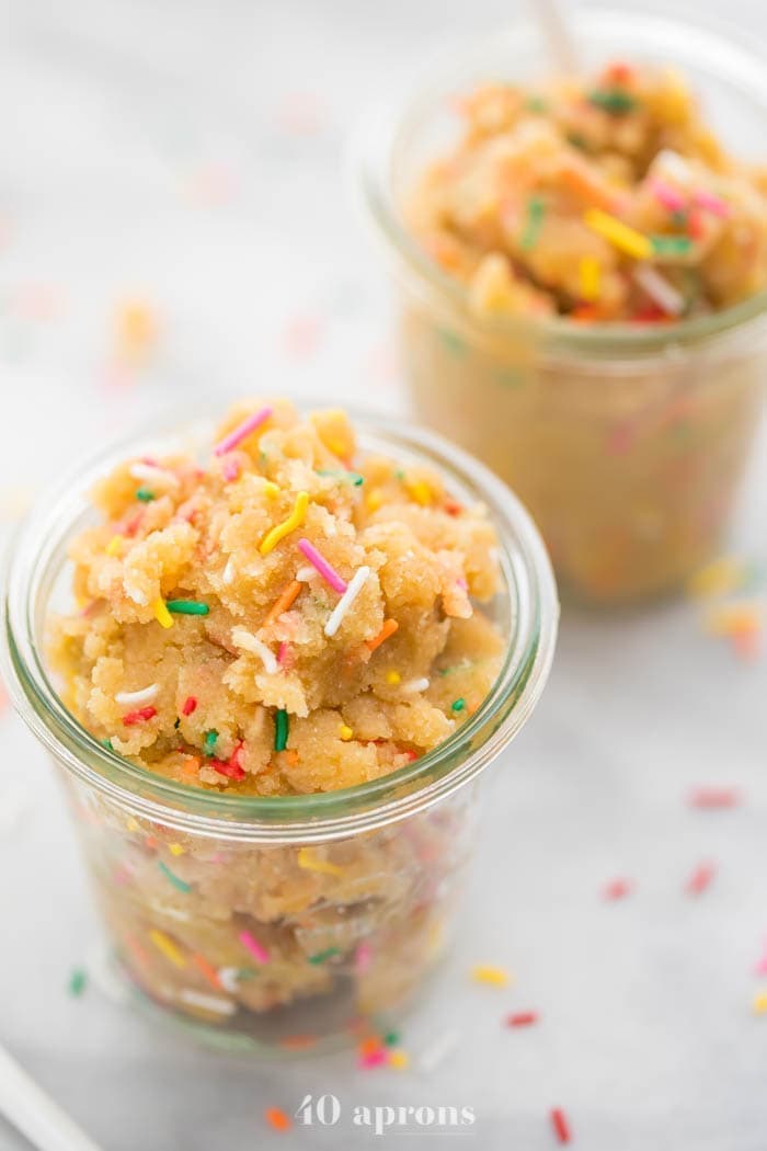 Edible healthy cake batter dip (paleo and vegan) with colourful sprinkles in jars