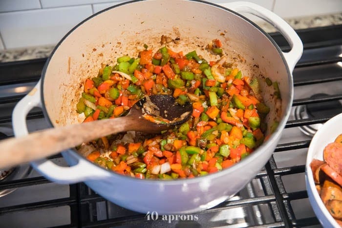 Sauté onion, bell peppers, garlic, and celery until softened then add spices