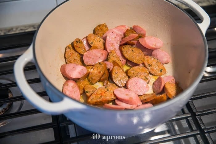 Brown sausage slices in a Dutch oven