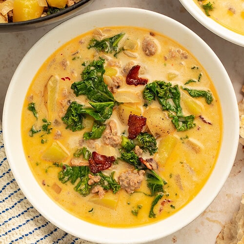 White bowl of zuppa toscana pictured overhead.