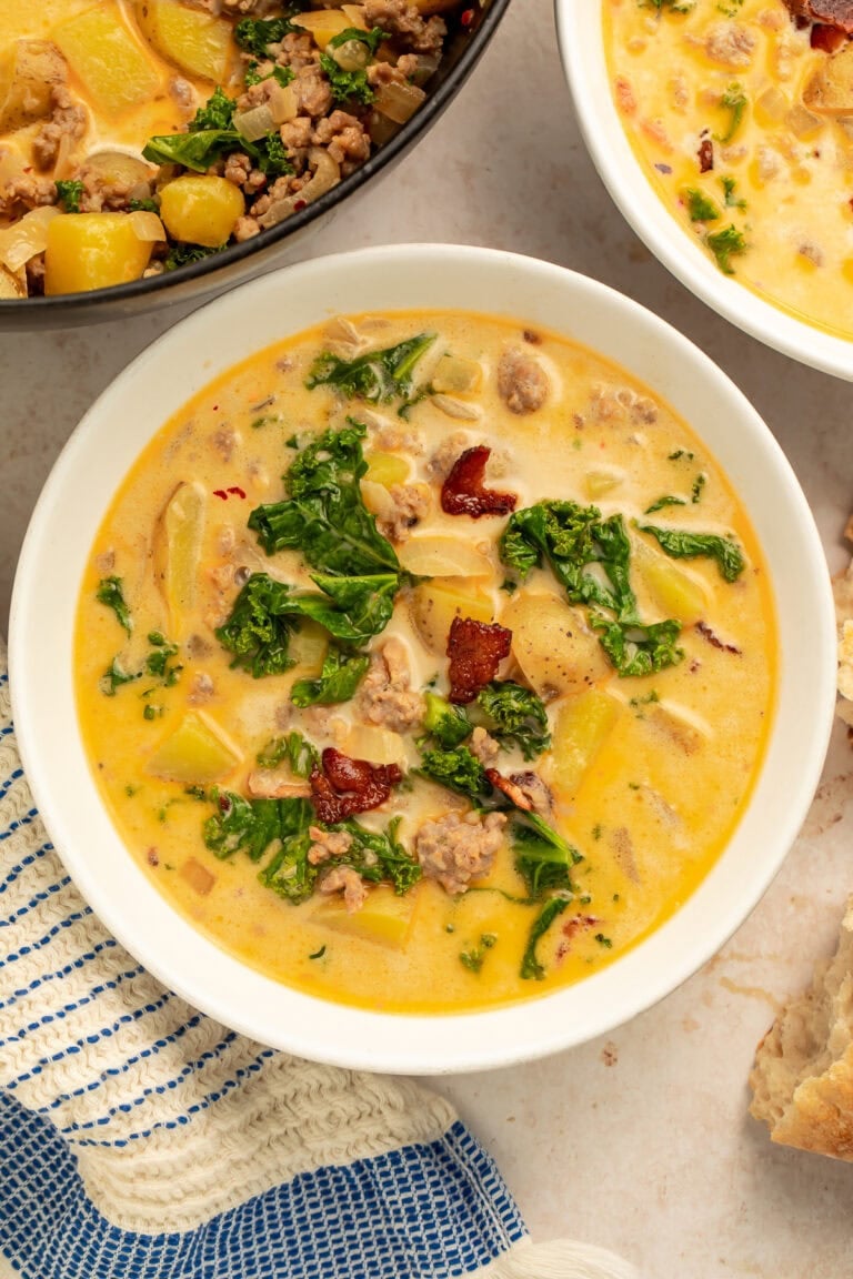 White bowl of zuppa toscana pictured overhead.