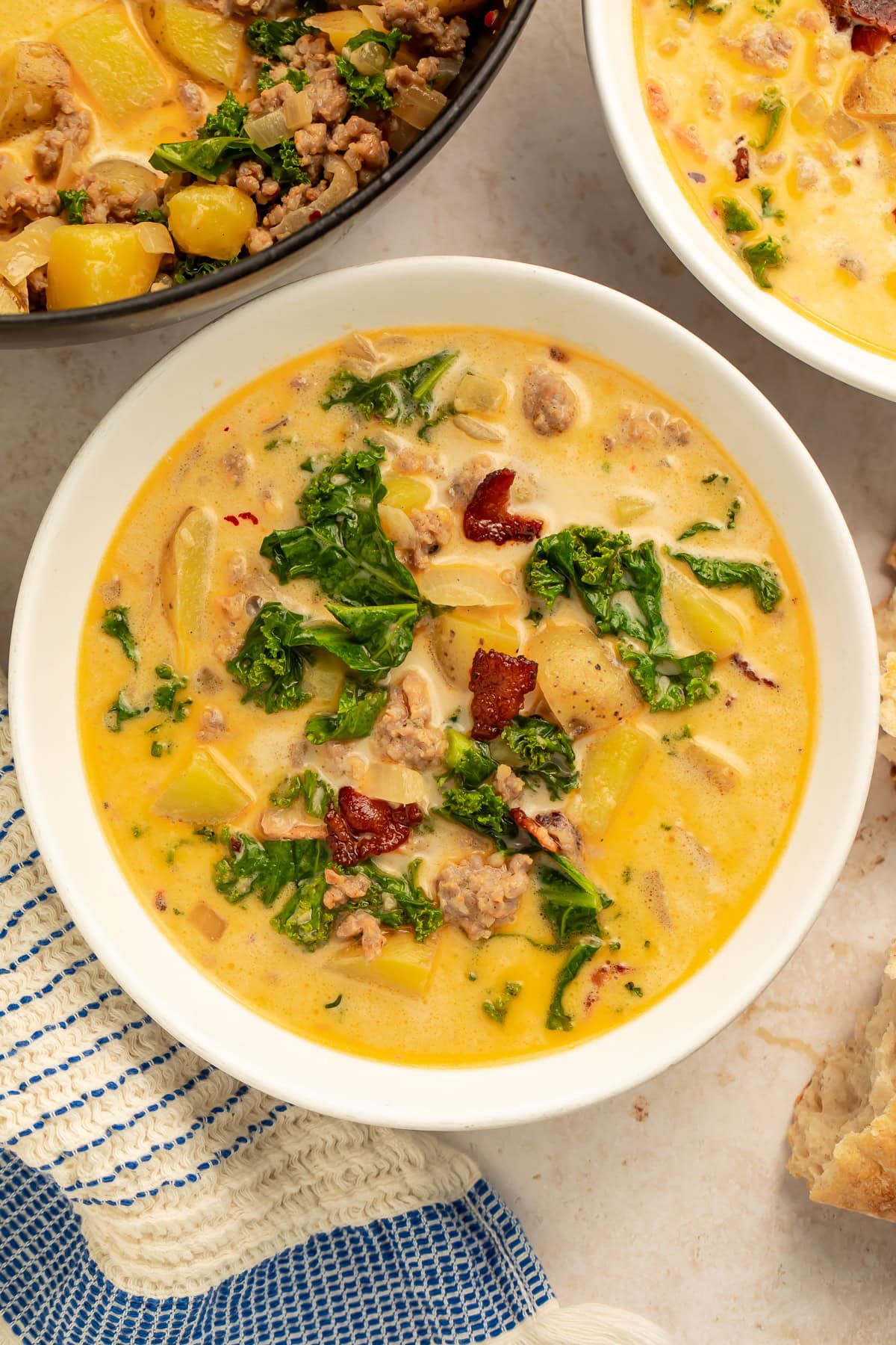 White bowl of zuppa toscana pictured overhead.