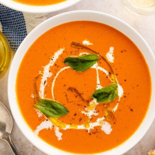 Two bowls of Instant Pot tomato soup on a table.