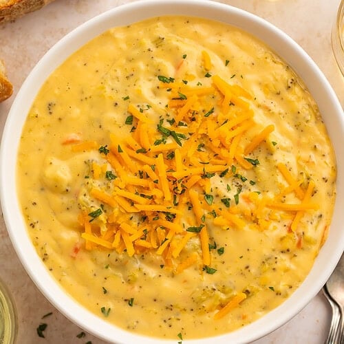 Overhead view of dairy free broccoli cheese soup with bread and wine