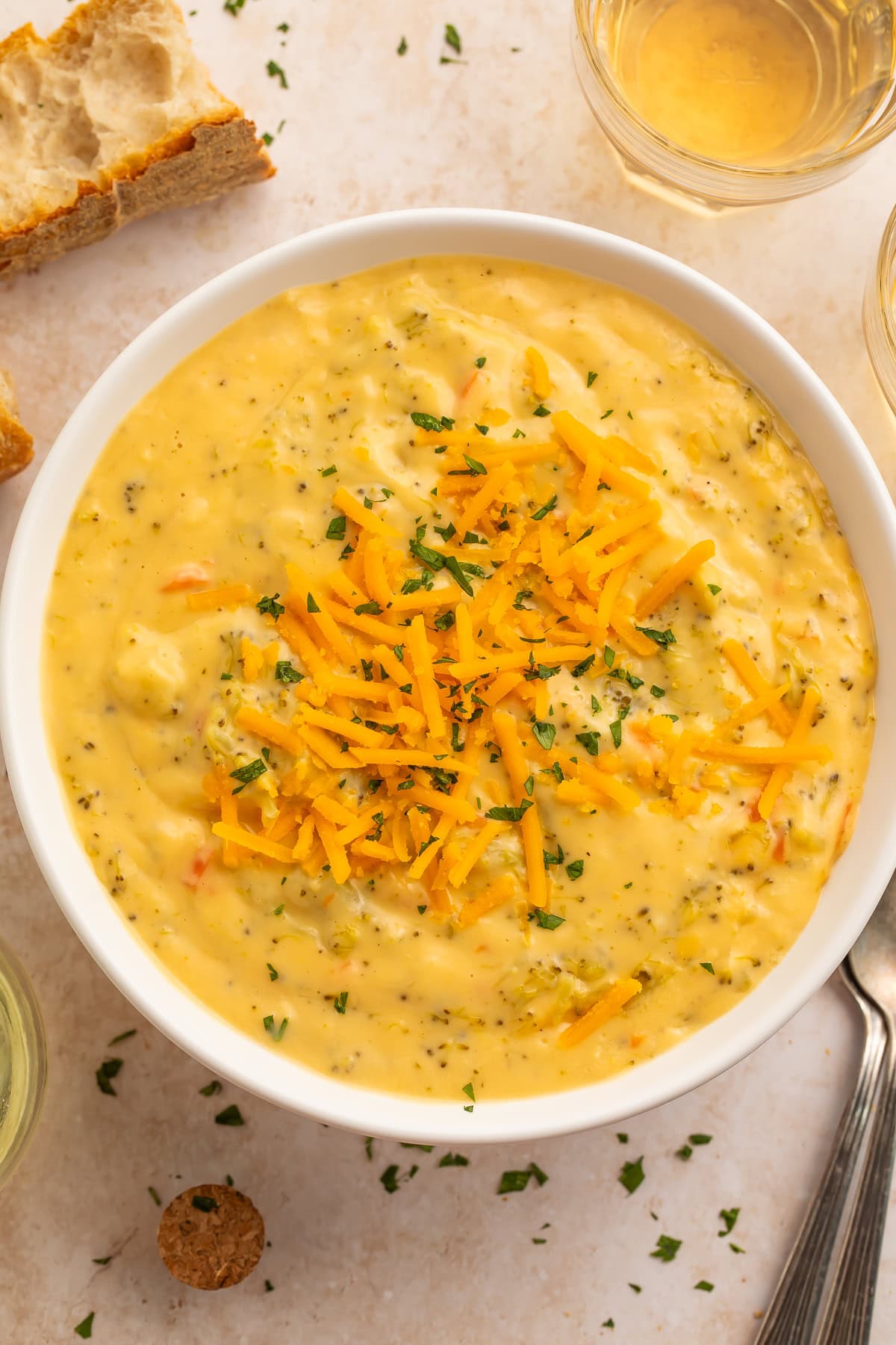 Overhead view of dairy free broccoli cheese soup with bread and wine