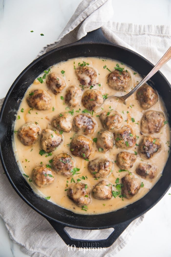 Paleo Swedish meatballs in creamy Swedish meatballs sauce in a cast iron skillet overhead