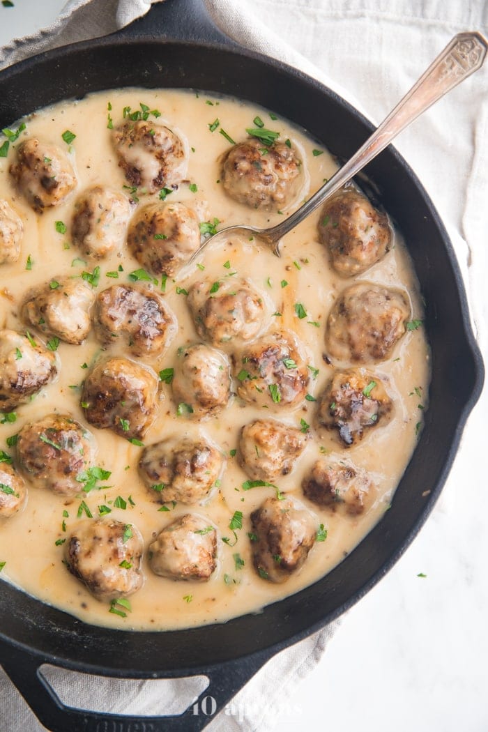 Paleo Swedish meatballs in creamy Swedish meatballs sauce in a cast iron skillet overhead