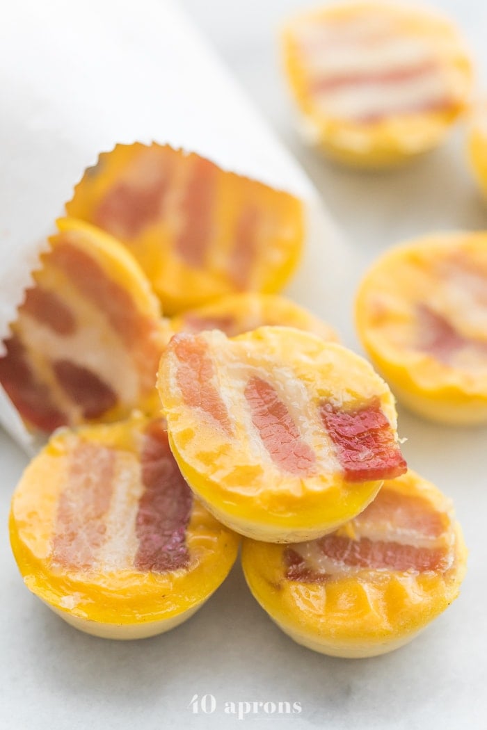 Healthy sous vide egg bites with bacon coming out of a white paper bag
