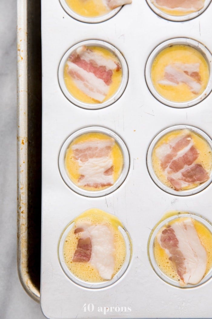 Healthy sous vide egg bites with bacon ready to be baked in a muffin pan