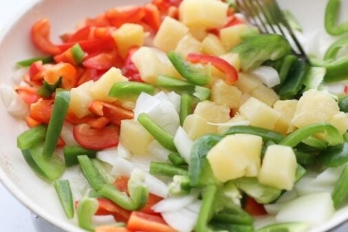 Sauté peppers, onions, and pineapple