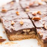 Batch of healthy paleo and vegan turtle bars on parchment paper