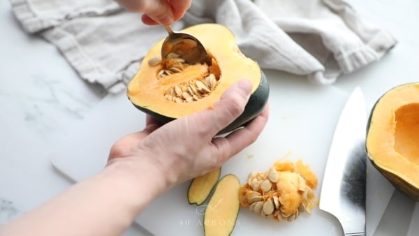 Cut acorn squash in half and scoop out seeds