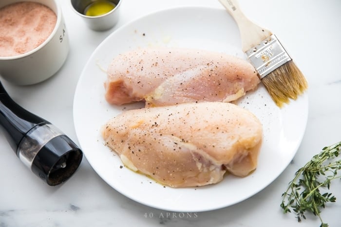 Season chicken breasts with pepper