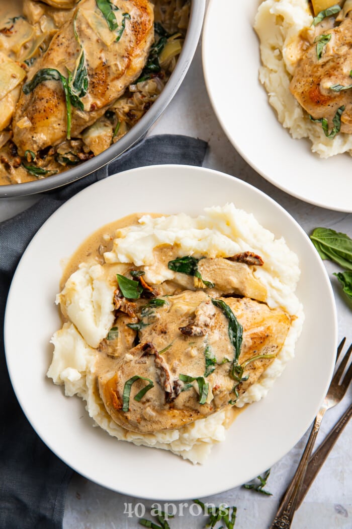 Whole30 Tuscan chicken plated with mashed potatoes 