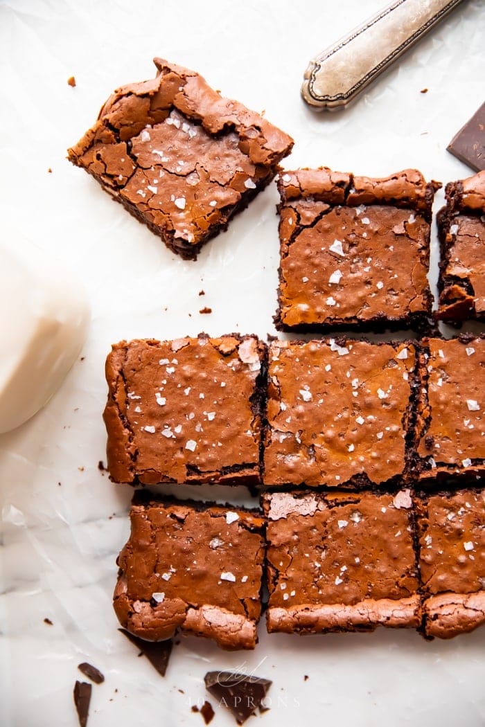 A batch of perfect paleo brownies shot overhead, with an antique knife to the side 