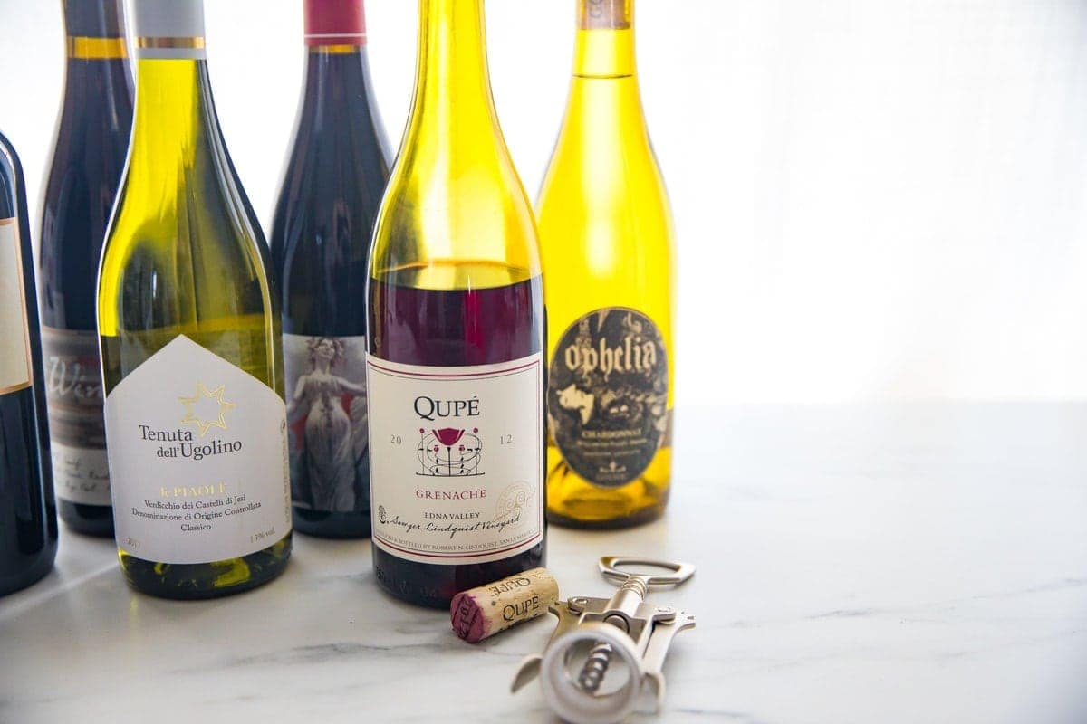 Group of organic red and white wine bottles with backlighting