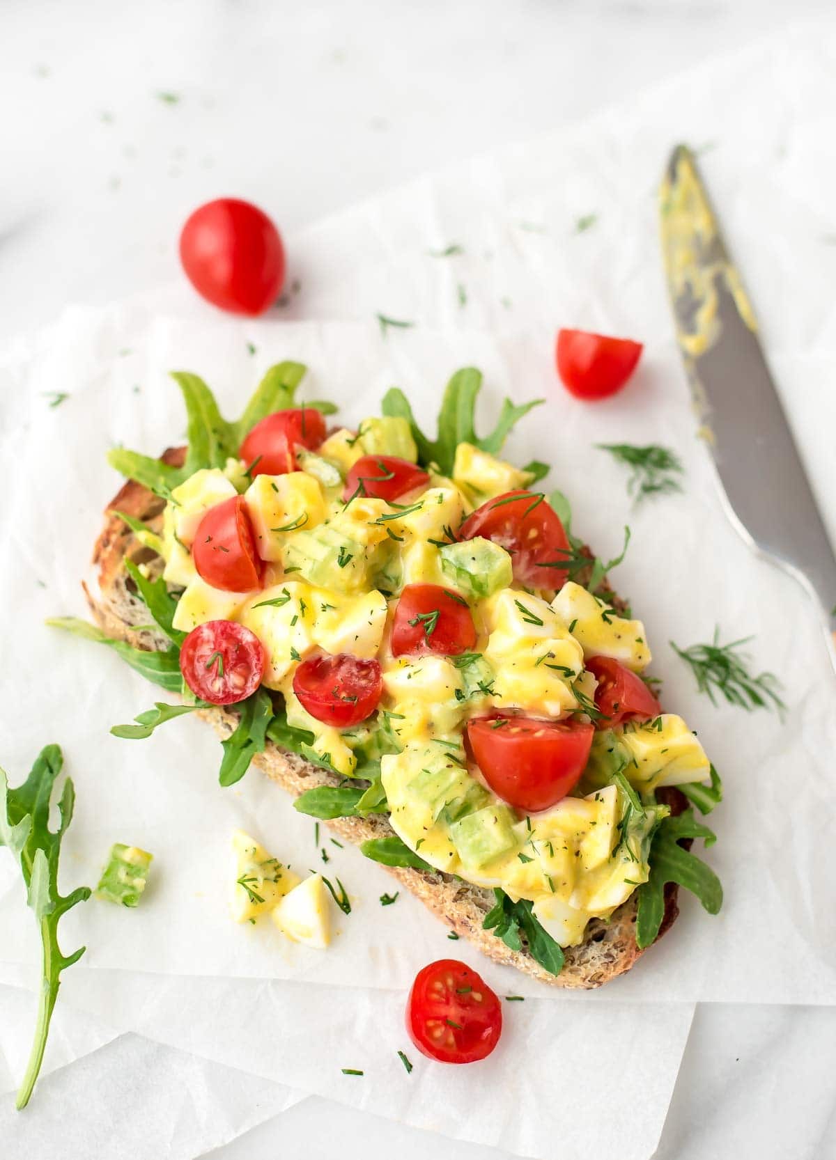 overhead shot of healthy egg salad on a slice of sourdough bread